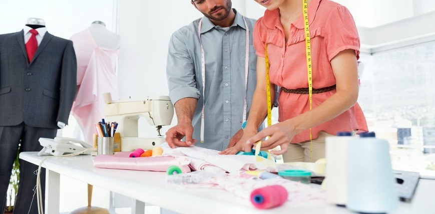 Fashion designers at work in bright studio